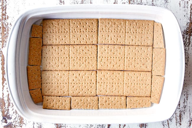 showing how to make Chocolate Eclair Cake by adding graham crackers in a single layer to a 9x13 pan