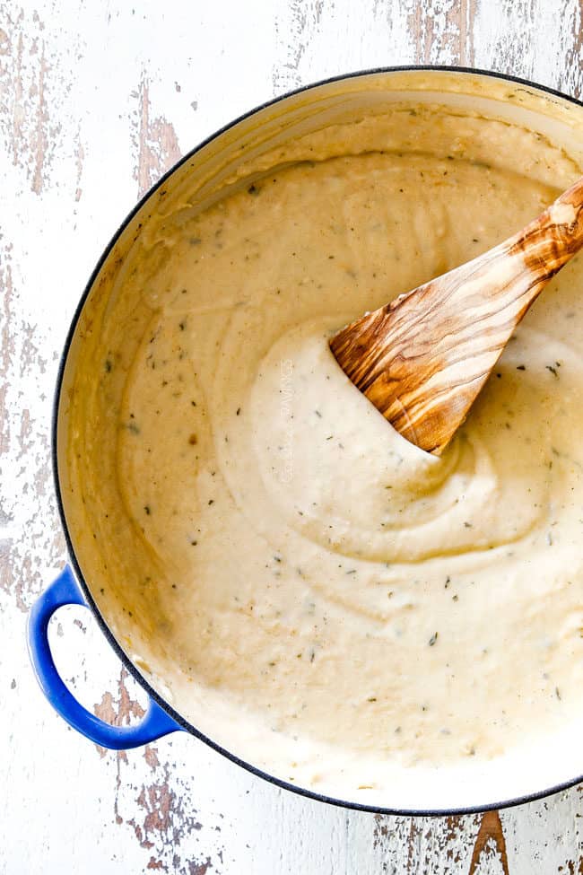 top view of creamy mornay sauce for chicken divan in a blue saucepan