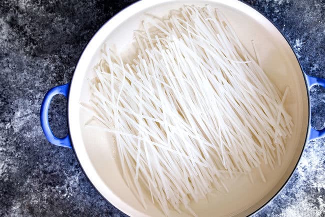 showing how to make authentic Laksa by soaking rice noodles in a pot of water..