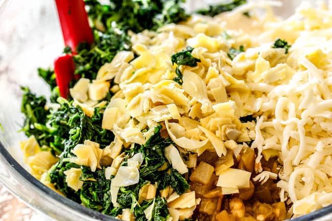 showing how to make spinach and artichoke dip recipe by adding spinach, artichokes, cream cheese, sour cream, mayonnaise, mozzarella and Parmesan cheese to a glass bowl