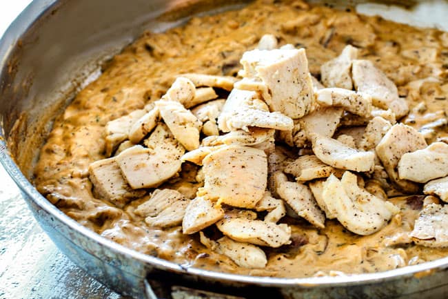 showing how to make Chicken Stroganoff by adding chicken back to Stroganoff sauce