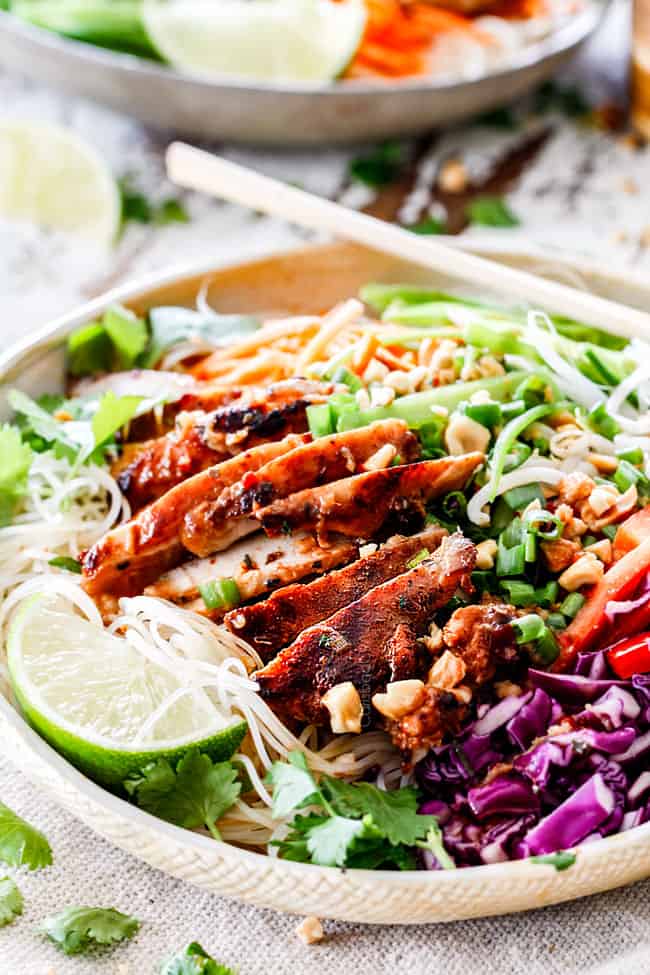 far away view of Vietnamese noodle recipe with rice noodles, lemongrass chicken, shredded carrots, julienned carrots, bean sprouts and snow peas