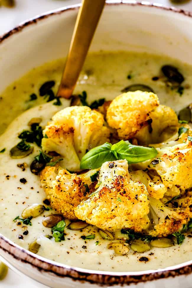 up close of a bowl of easy cauliflower soup garnished with pepitas