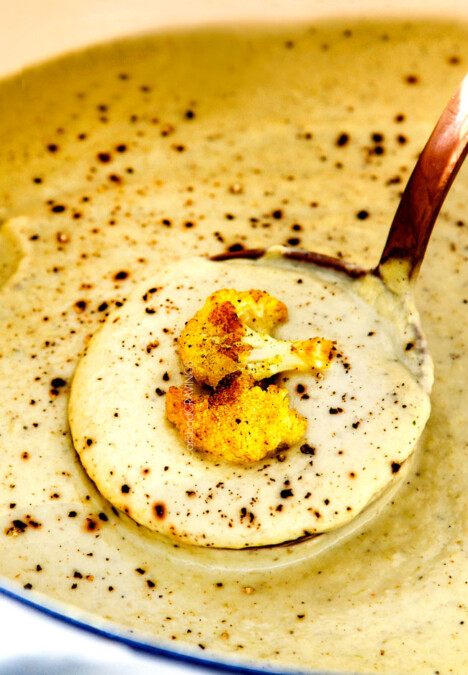up close of a ladle full of creamy Cauliflower Soup in the pot