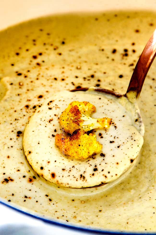 up close of a ladle full of creamy Cauliflower Soup in the pot