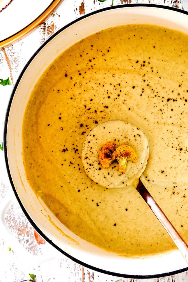 top view of easy cauliflower soup in a white soup pot with a ladle.