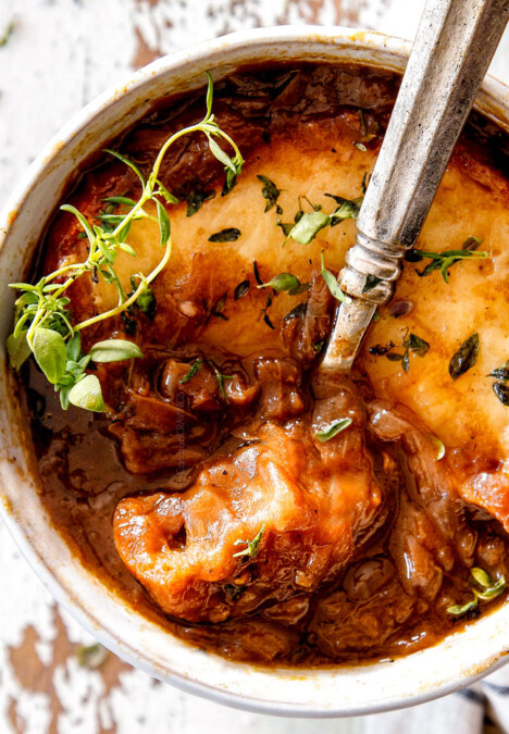 up close of top view of Best French Onion Soup with a spoonful of cheesy bread