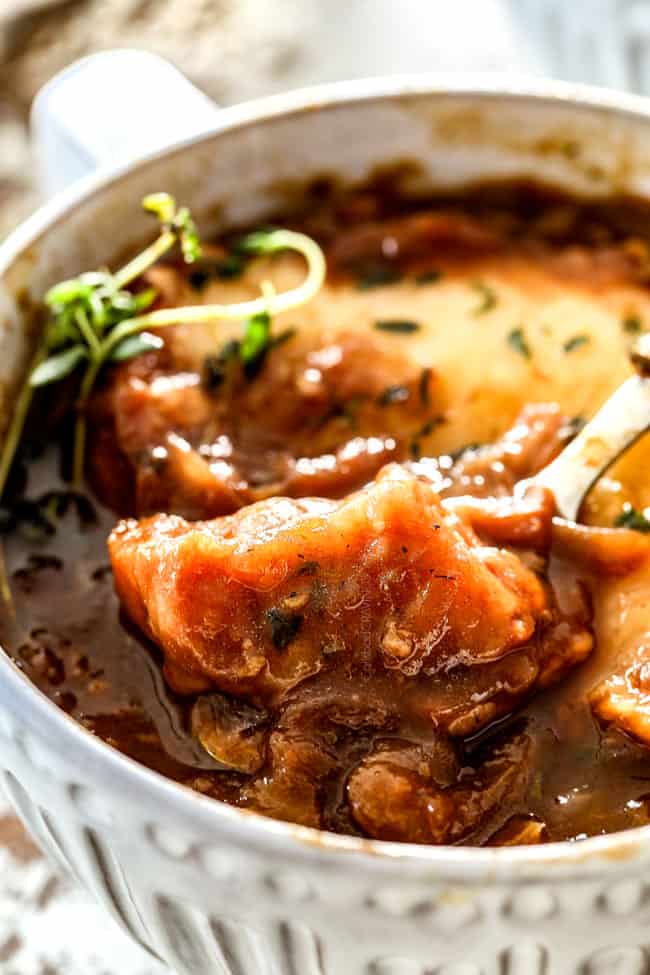 up close of a spoonful of cheesy bread in French Onion Soup