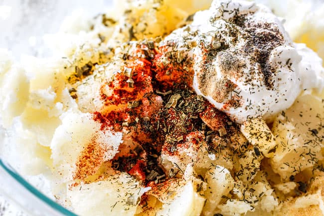 showing how to make twice baked potatoes by adding potato flesh, sour cream, milk, butter, paprika, parsley, dill, salt and pepper