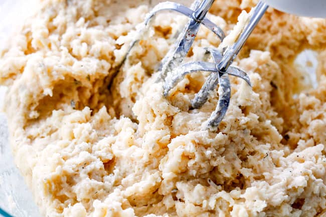 showing how to make twice baked potatoes by mashing potato filling together