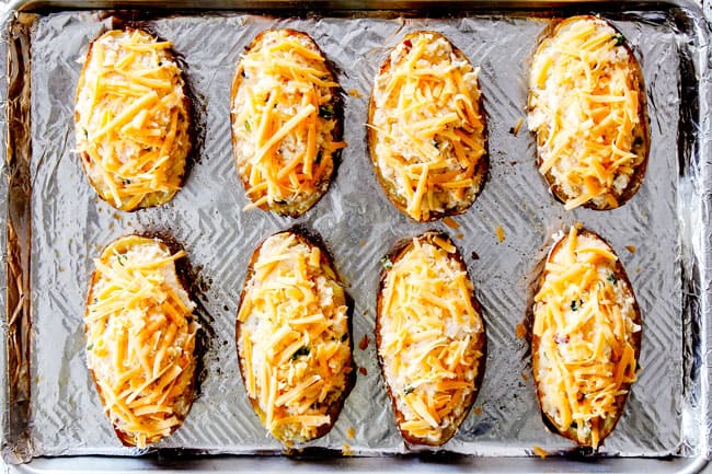 showing how to make twice baked potatoes by lining potato halves on a baking sheet and topping with chese
