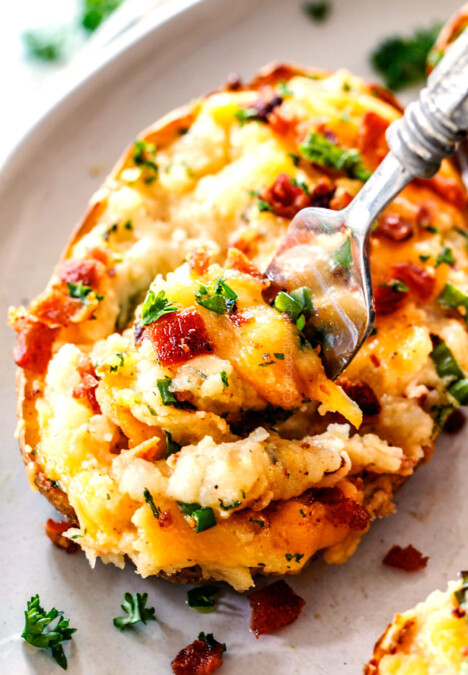 a fork taking a bite out of best twice baked potatoes