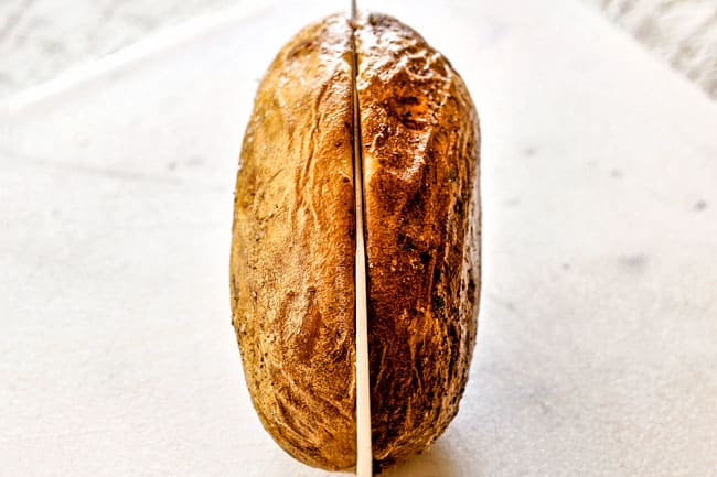 showing how to make twice baked potatoes by slicing them in half