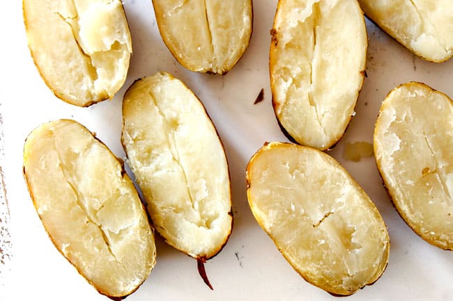 top view of potato halves on a white cutting board