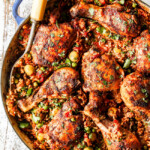 up close of arroz con pollo in a pot with peas