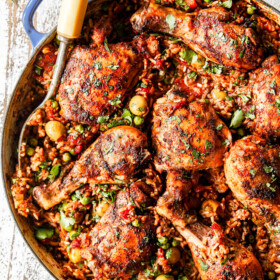 up close of arroz con pollo in a pot with peas
