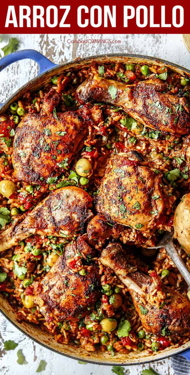 up close of arroz con pollo in a pot with peas and olives