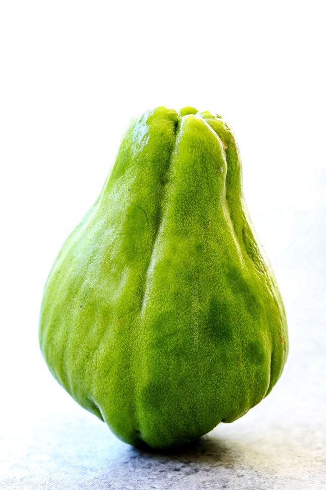 chayote on a cutting board ready to cut for Caldo de Pollo