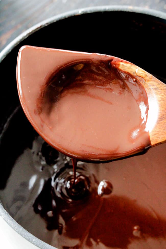 5 Minute Fool Proof Chocolate Ganache (sauce) is silky, creamy, sweet and 1,000 TIMES BETTER than any store bought chocolate sauce. Perfect for brownies, ice cream, cakes, popcorn, strawberries, etc showing how to make chocolate ganache by stirring it with a wooden spoon once melted