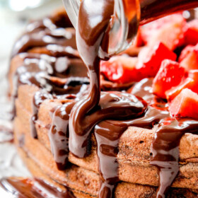 pouring chocolate syrup over hershey chocolate waffles