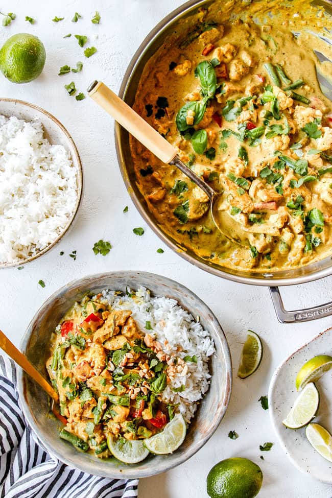 top view of easy coconut curry chicken in a stainless still skillet and in a bowl with rice