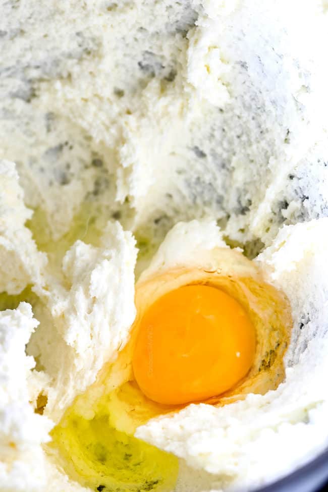 showing how to make Kentucky Butter Cake by adding eggs to mixer