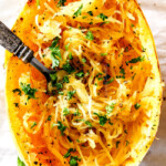 top view of baked spaghetti squash with a fork in the strands