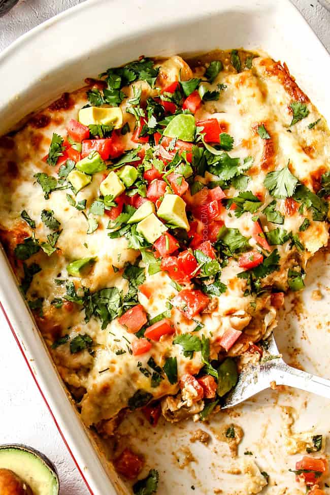 top view of half eaten enchiladas verdes suzias with a spatula