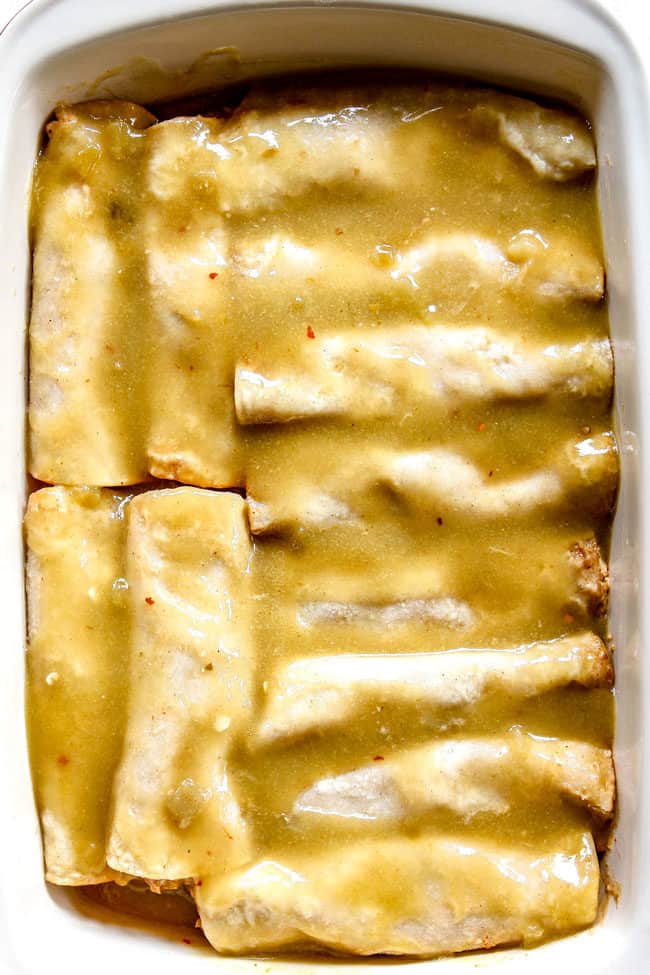showing how to make chicken enchiladas by pouring green enchilada sauce over tolled tortillas