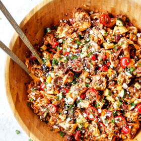 top view of healthy Greek Pasta Salad in a wood bowl
