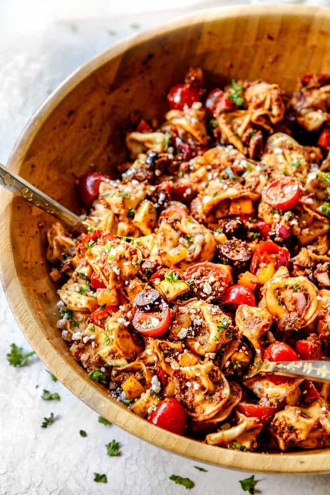 side view of best Greek pasta salad in a wood bowl