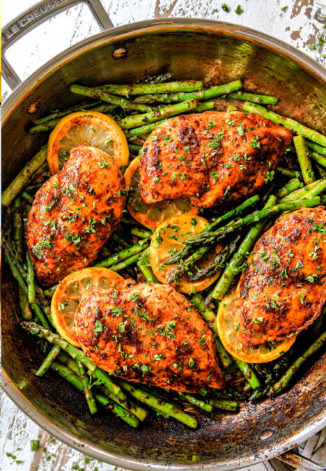 top view of lemon pepper chicken and asparagus in a skillet