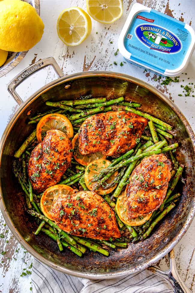 far away top view of lemon pepper chicken and asparagus in a skillet