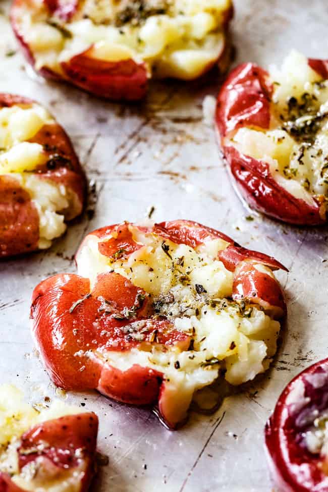 showing how to make smashed potatoes by lining smashed, buttered potatoes on a baking sheet