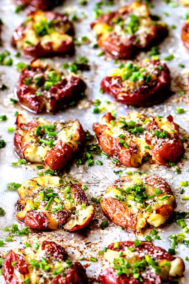 rows of garlic smashed potatoes on a baking sheet