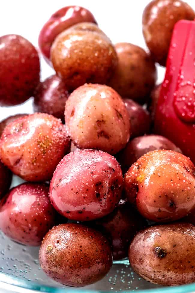 showing how to make smashed potatoes with a top view of potatoes lined on a baking sheet