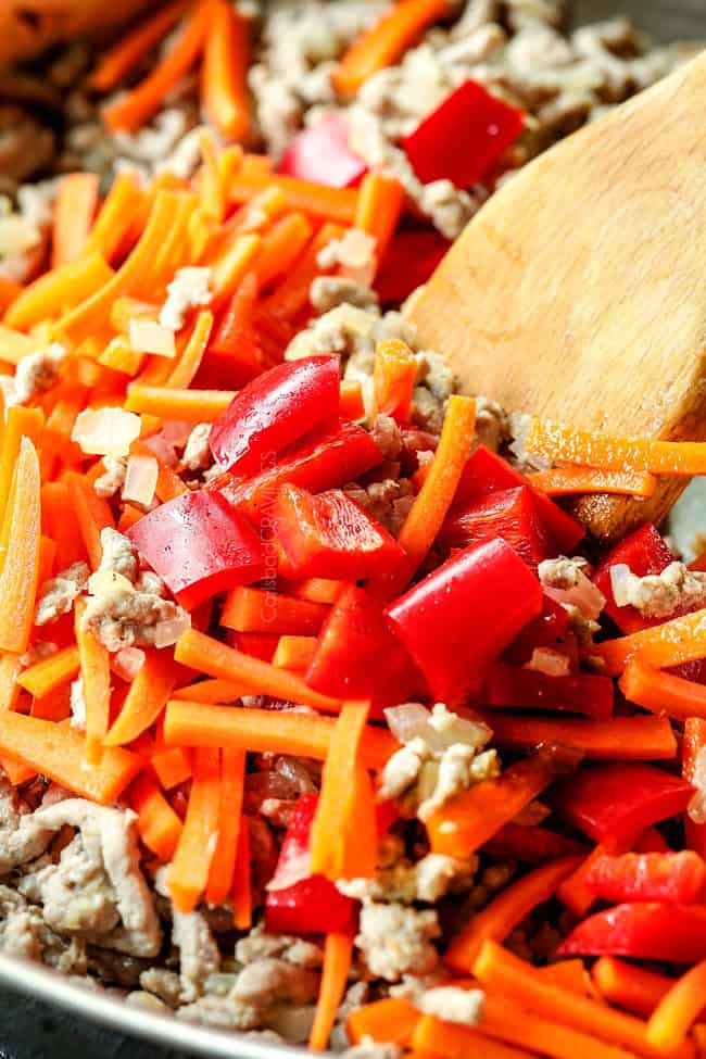 showing how to make ramen by sauteeing carrots, onions, bell peppers