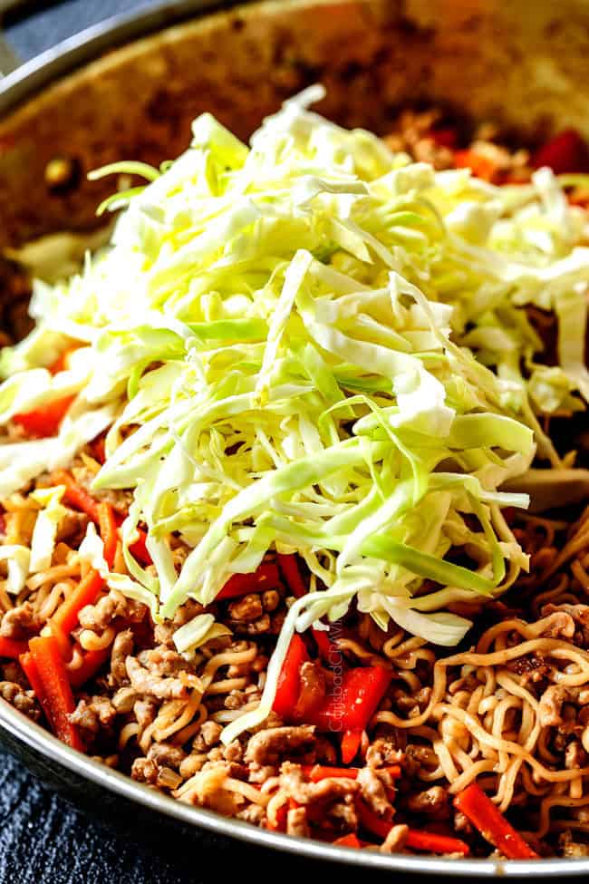 showing how to make ramen by adding cabbage to spicy chicken