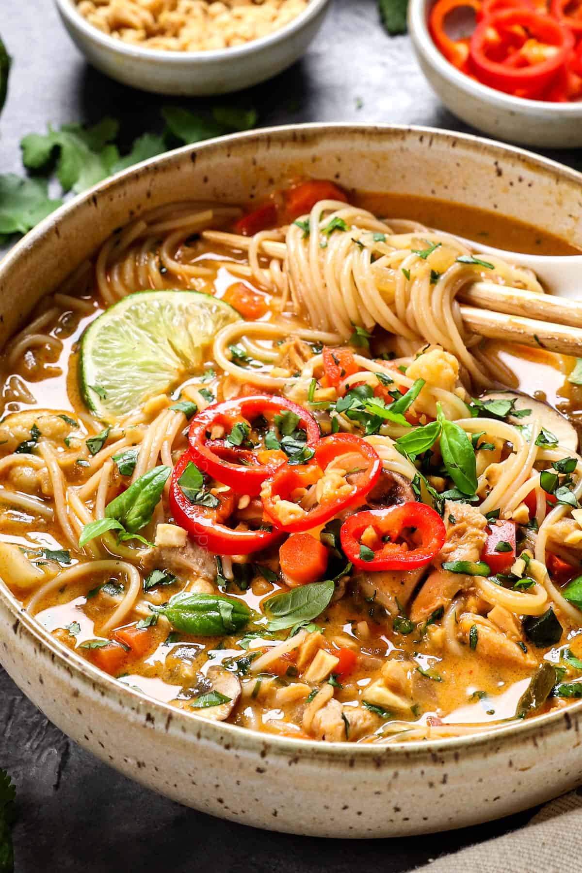 Thai noodle soup in a bowl with coconut milk, chicken broth, ginger, garlic