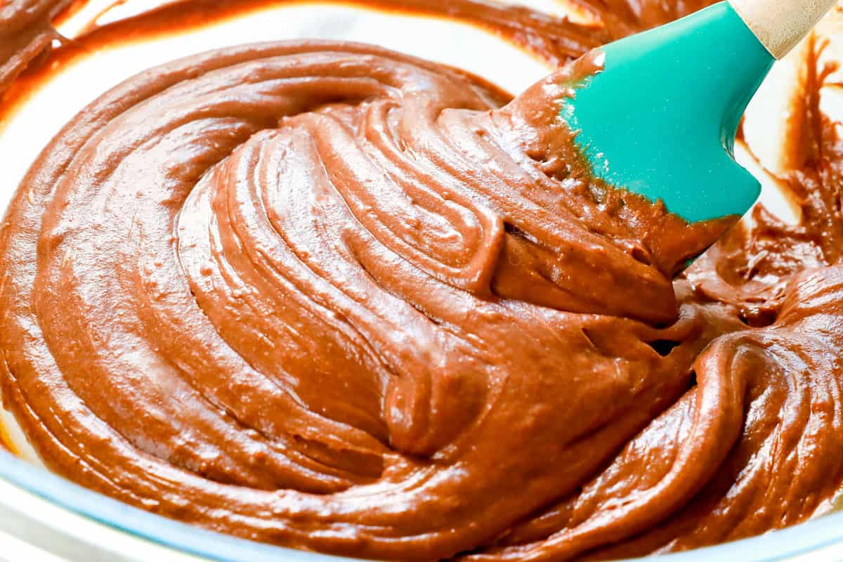 showing how to make Chocolate Lava Cake recipe by folding flour into batter