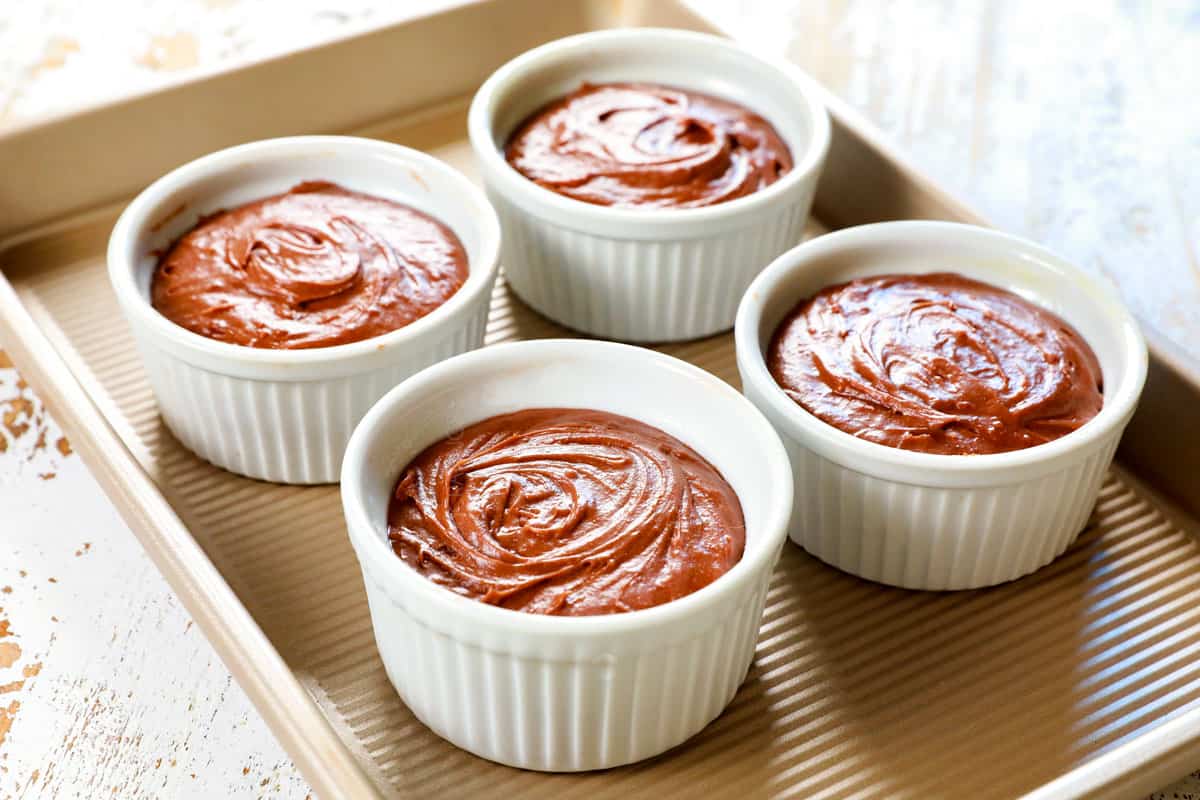 showing how to make chocolate lava cake recipe by adding batter to greased ramekins