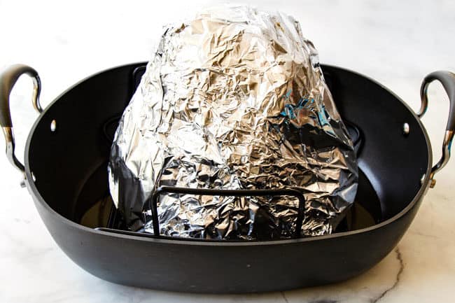 showing how to make honey baked ham recipe by wrapping ham tightly in foil