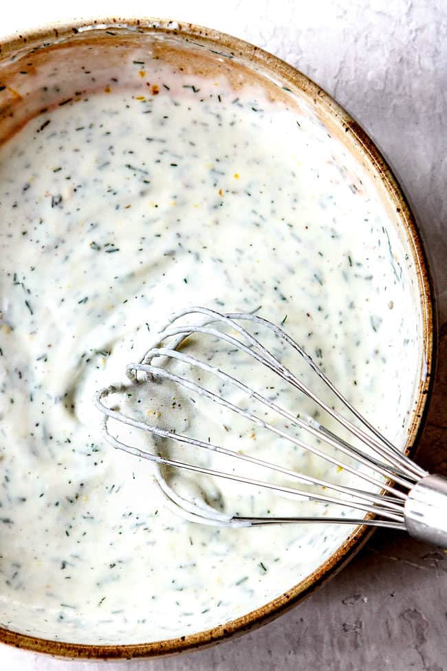 showing how to make dill sauce for salmon by whisking ingredients in a bowl until smooth