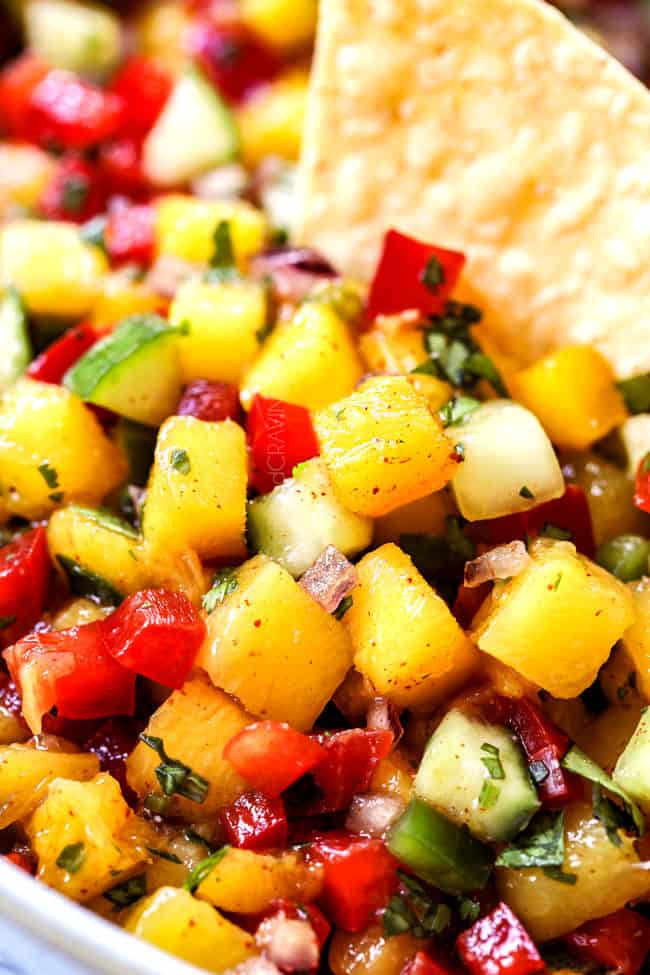 up close of a chip in easy mango salsa