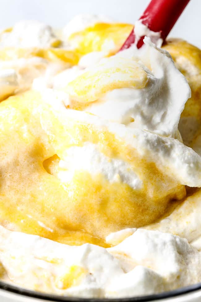 showing how to make strawberry shortcake cake by gently folding egg whites into batter