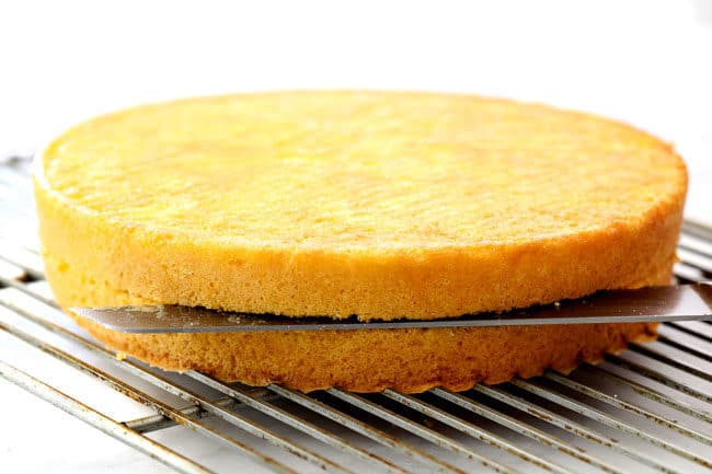 showing how to make strawberry shortcake cake by slicing sponge cake through the center to create two layers