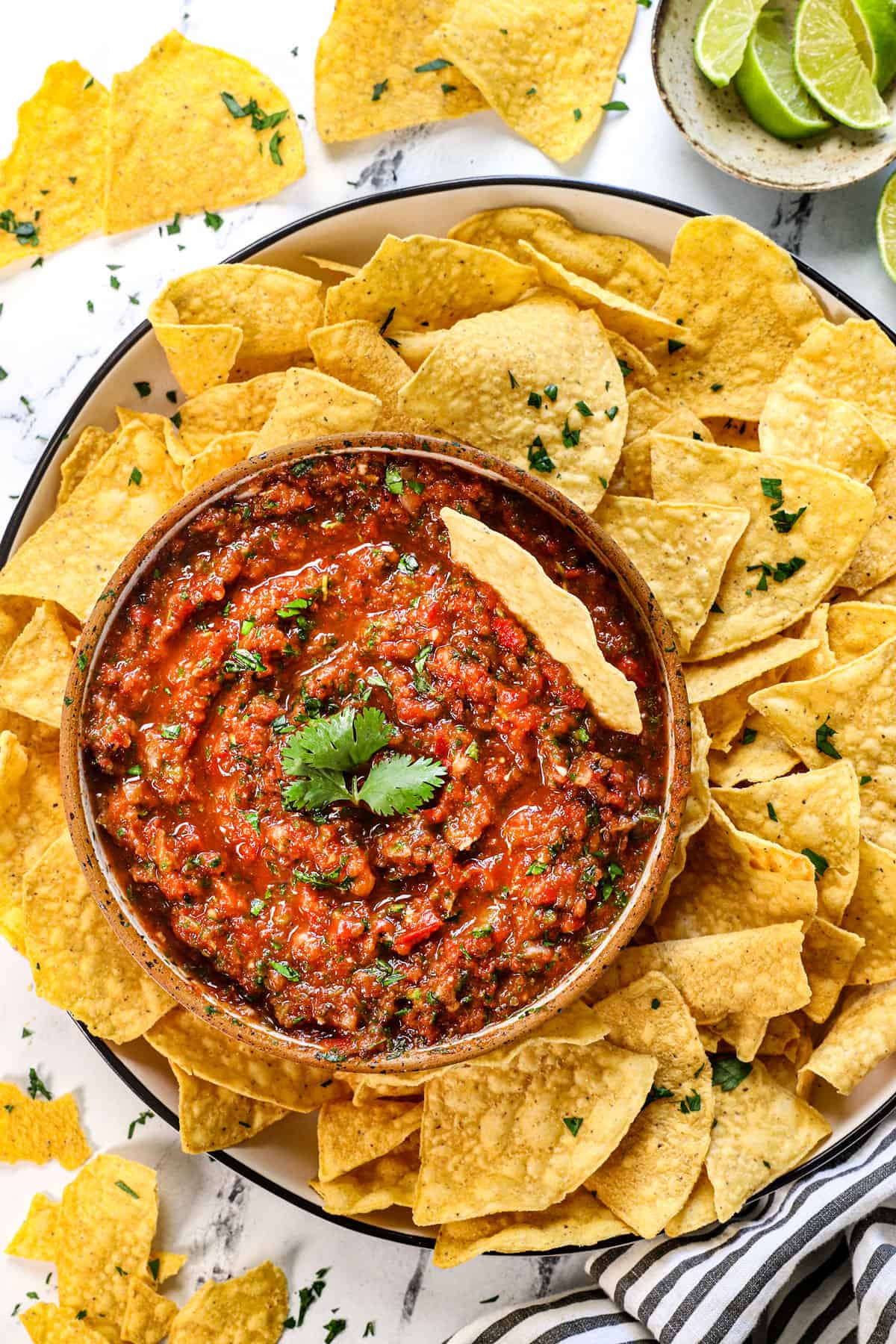 top view serving homemade salsa with chips on a platter