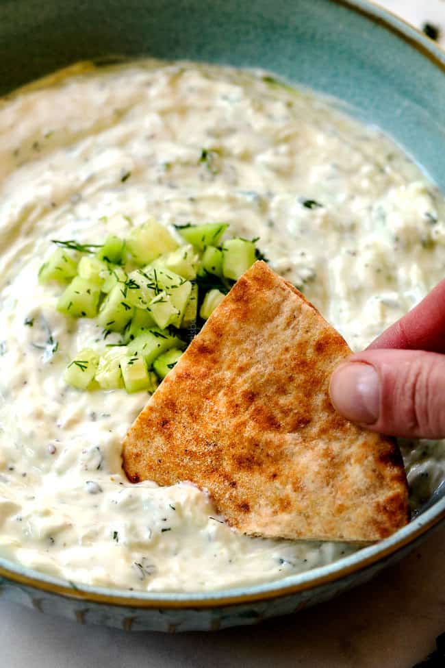 dipping a pita into the best Tzatziki recipe