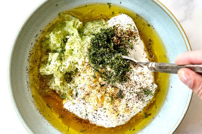 showing how to make Greek Chicken Kabobs by whisking tzatziki ingredients together in a bowl