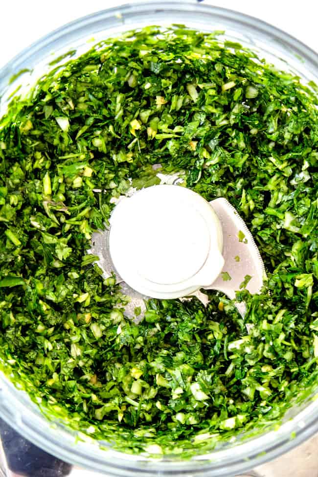 showing how to make grilled pork tenderloin by chopping chimichurri ingredients